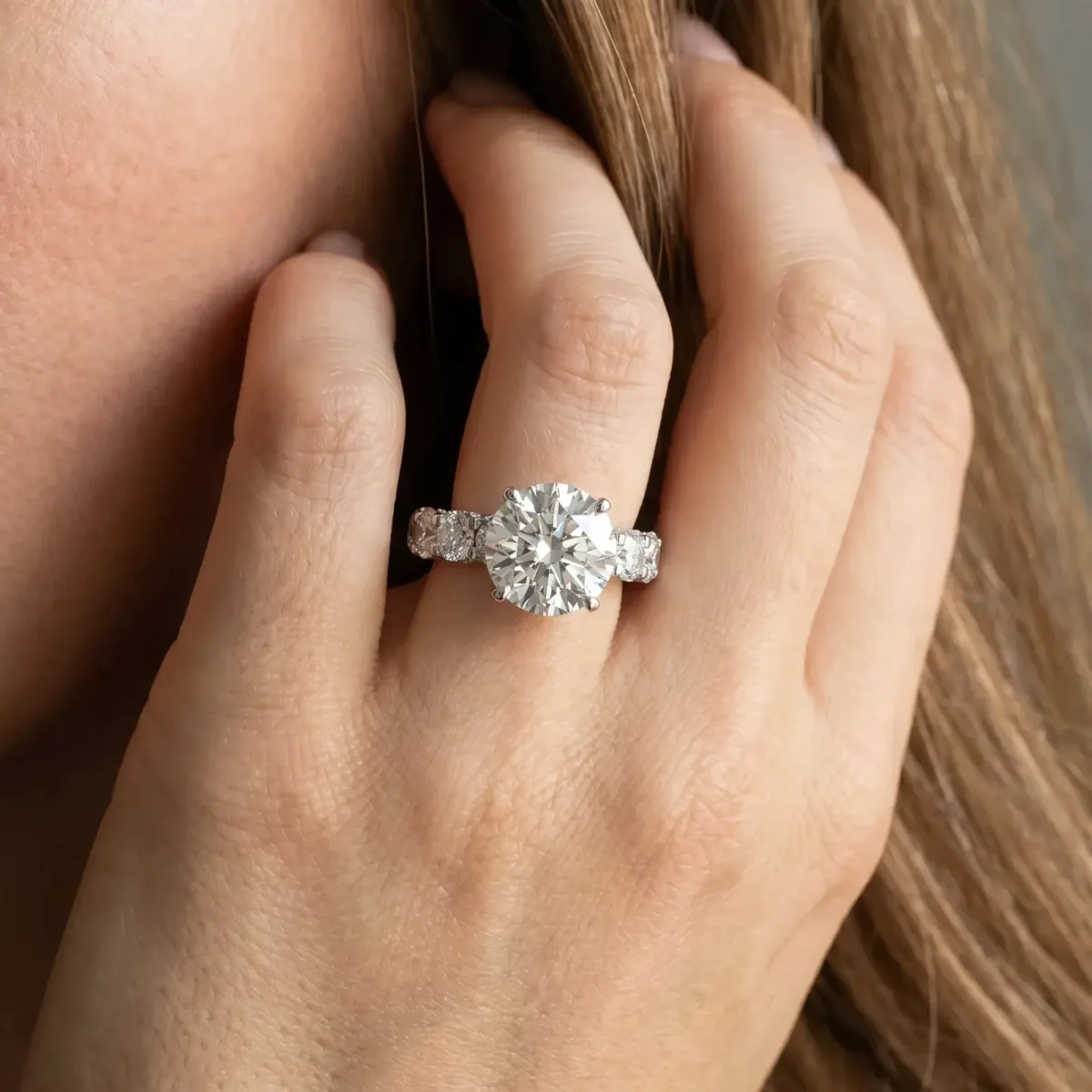 Round Cut Diamond Side Stone Engagement Ring with Four-Prong Setting Platinum