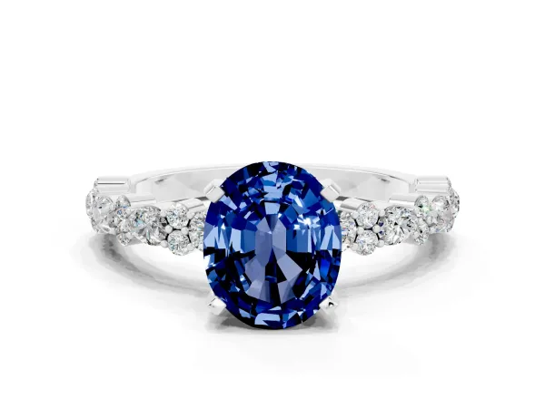 Oval Cut Blue Sapphire Side Stone Solitaire Ring with Round and Four-Prong Setting White gold