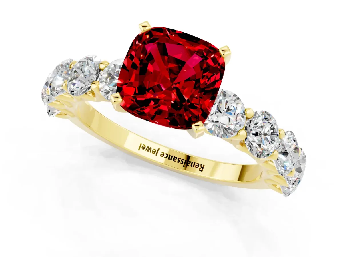 Cushion Cut Ruby Prong Setting with Side Stones on a Pave Band Yellow gold