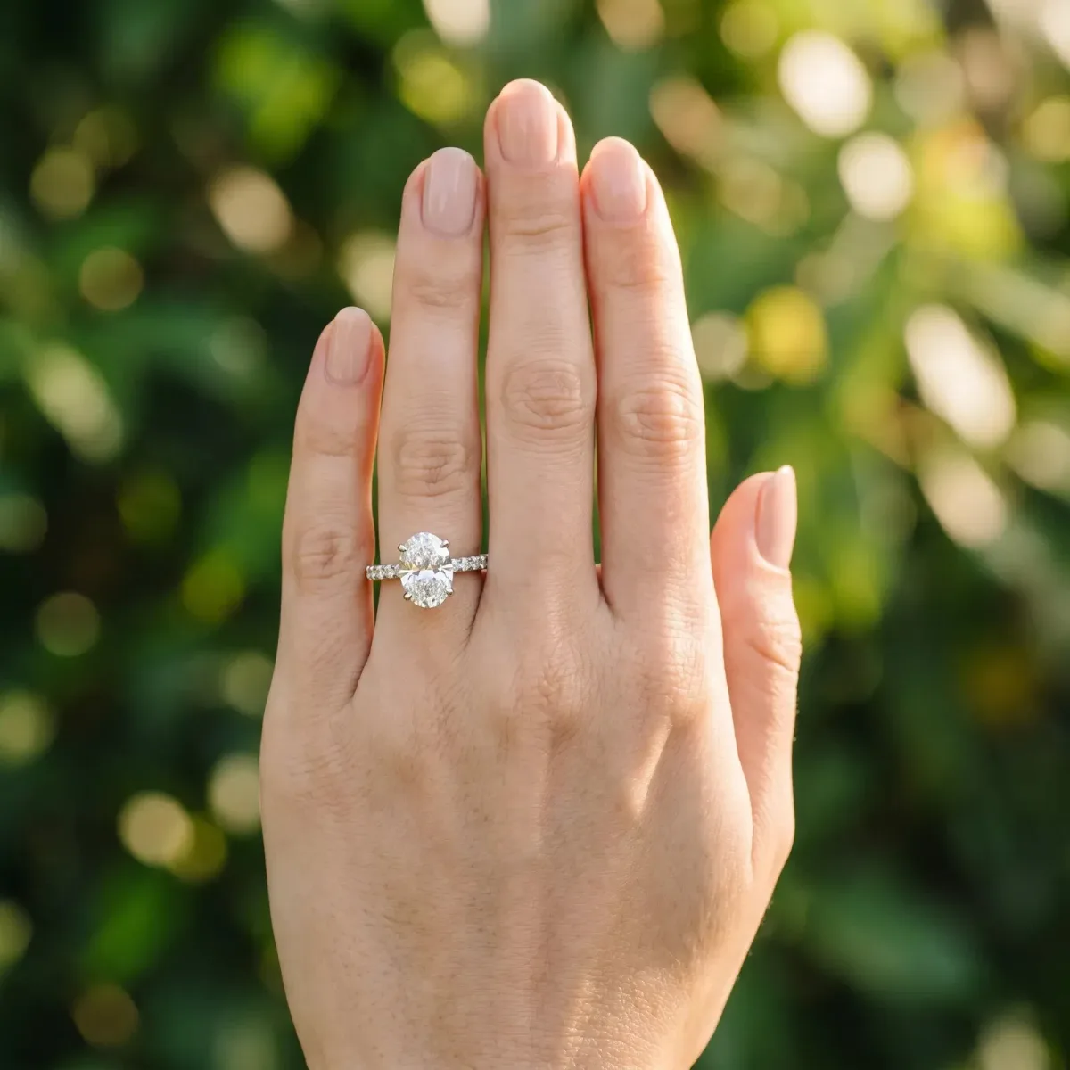 Oval Cut Diamond Solitaire Ring with Round Pavé Band and Four-Prong Setting Platinum