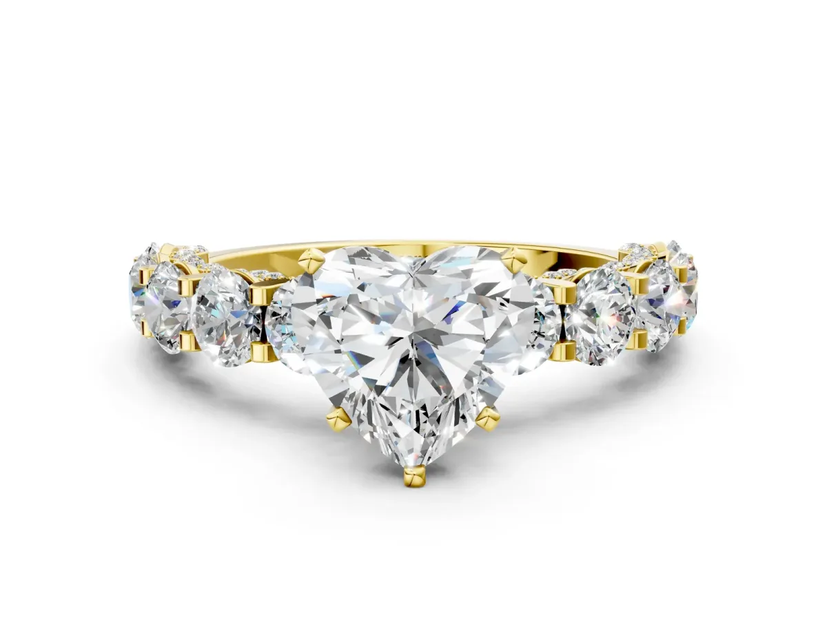 Heart Cut Diamond Side Stone Engagement Ring with Four-Prong Setting Yellow gold