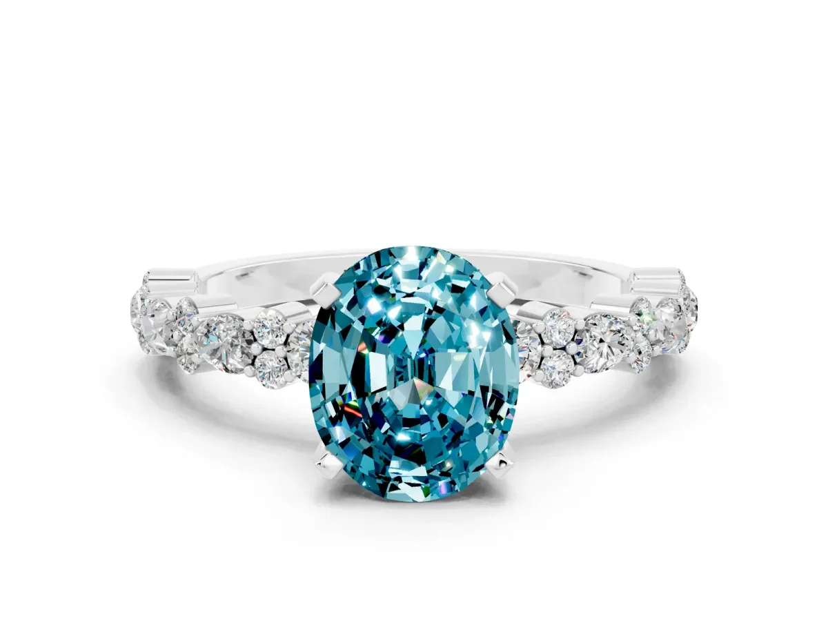 Oval Cut Blue Topaz Side Stone Solitaire Ring with Round and Four-Prong Setting Silver