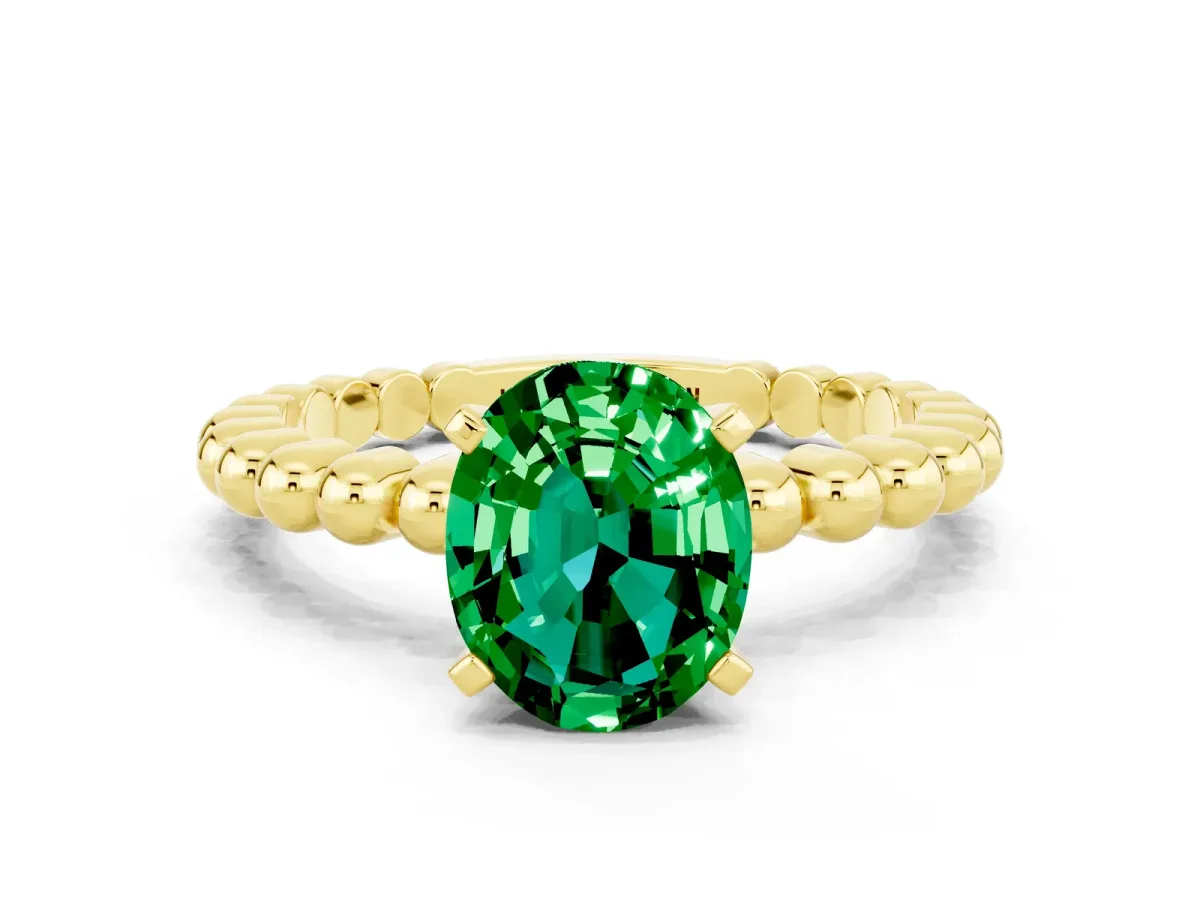 Oval Cut Emerald Solitaire Ring with Beaded Band and Prong Setting Yellow gold