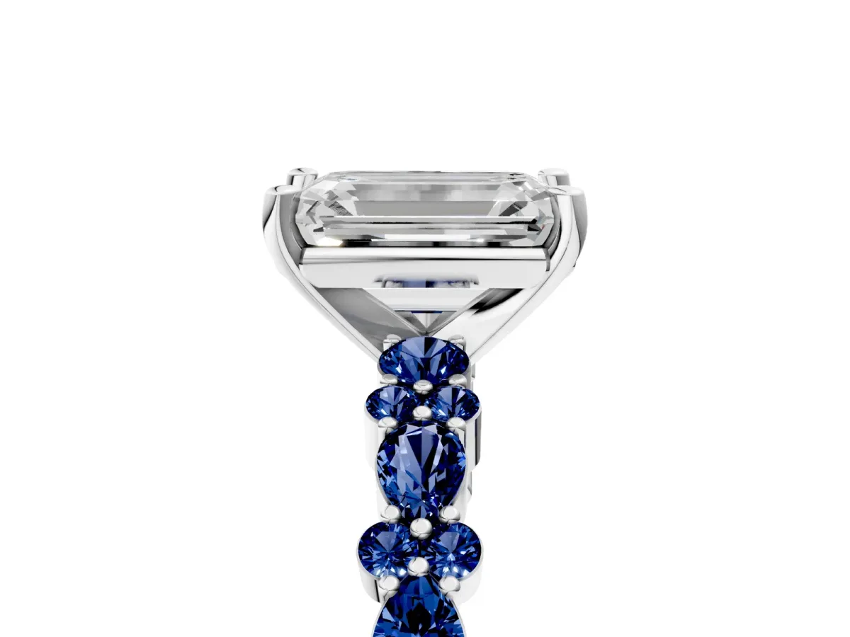 Emerald Cut Diamond Side Stone Solitaire Ring with Round Blue Sapphire and Four-Prong Setting Platinum