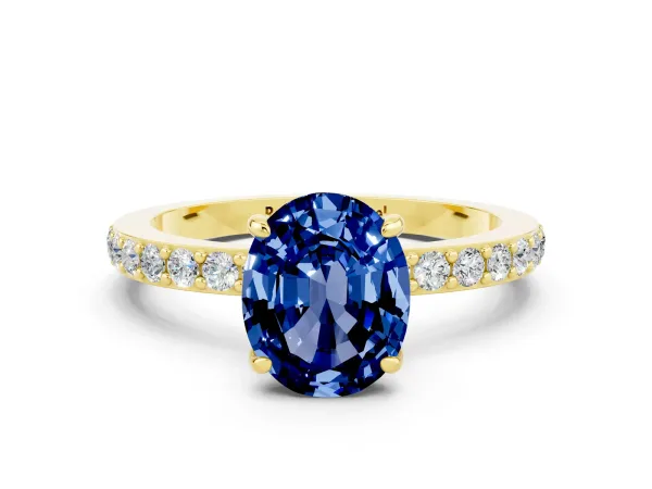 Oval Cut Blue Sapphire Solitaire Engagement Ring with Pavé Band and Four-Prong Setting Yellow gold