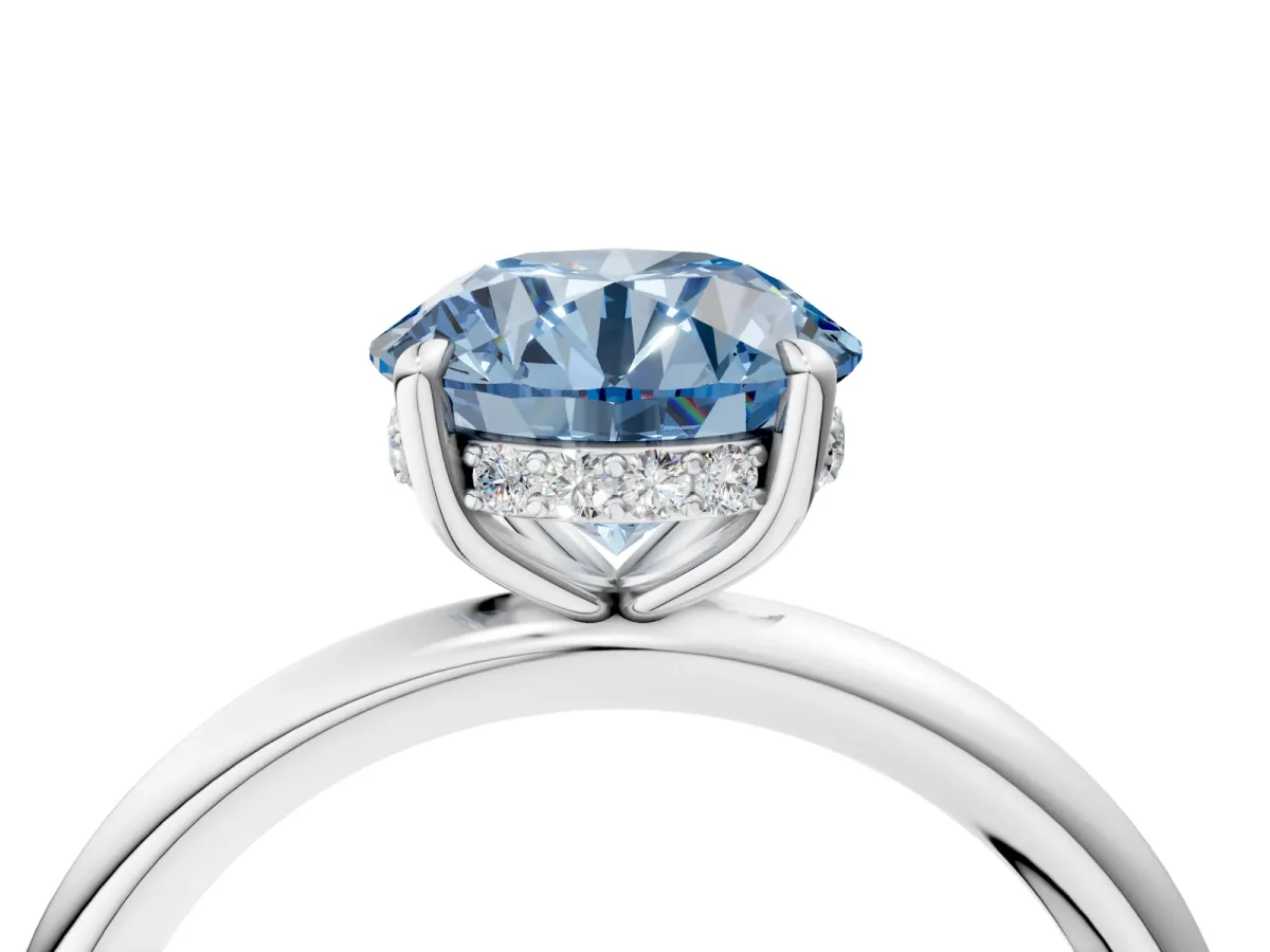 Fancy Blue Round Cut Diamond Solitaire Ring with Thin Band and Four-Prong Setting Silver