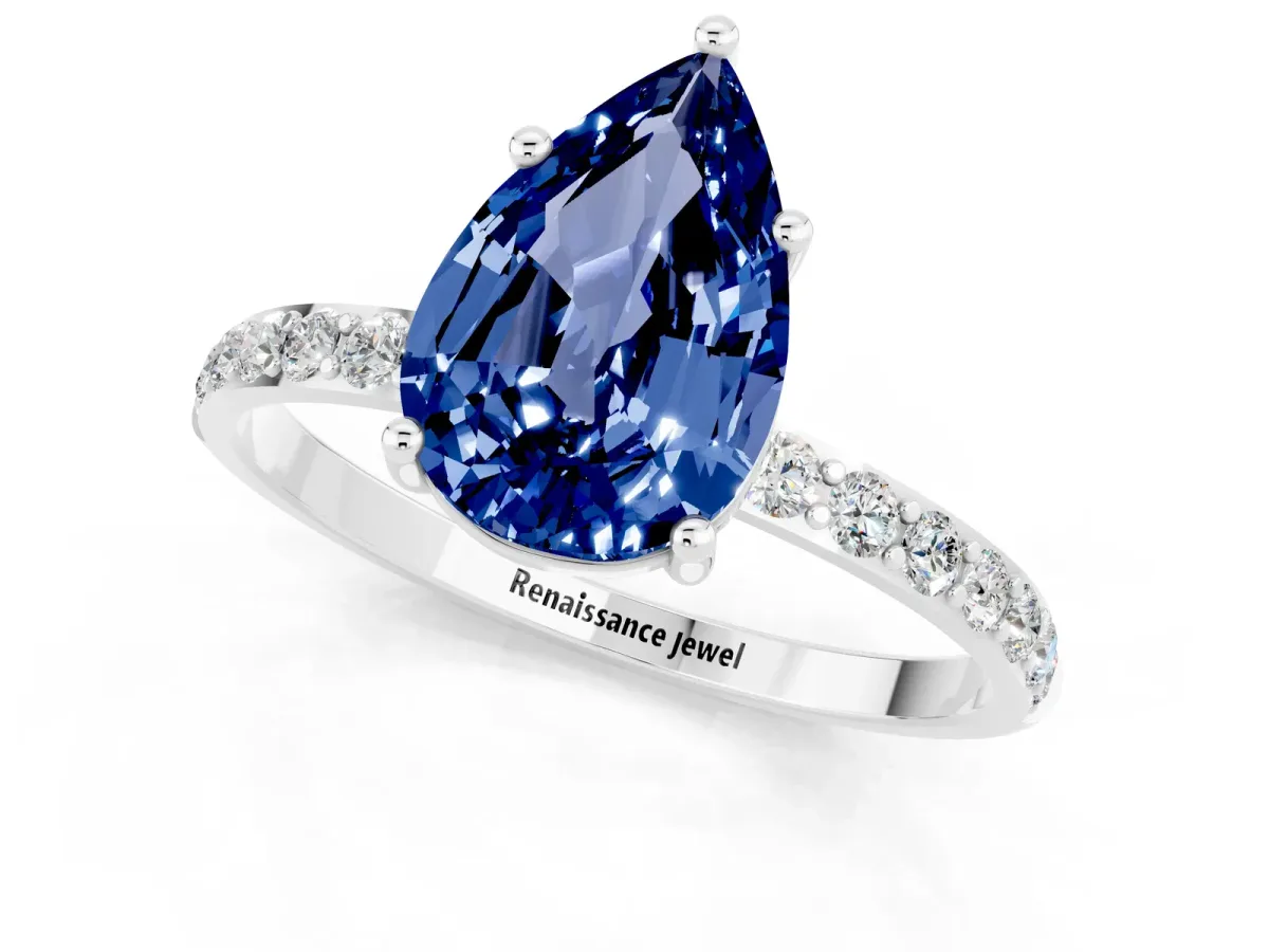 Pear Cut Blue Sapphire Solitaire Ring with Round Pavé Band and Prong Setting Silver