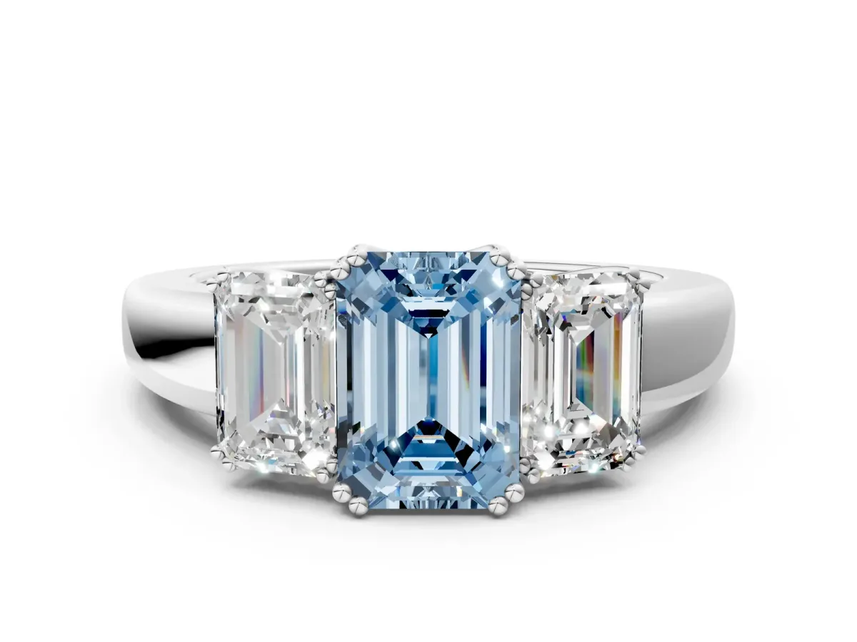 Fancy Blue Three-Stone Emerald Cut Cut Diamond Ring with Channel Set Band and Four-Prong Setting Silver
