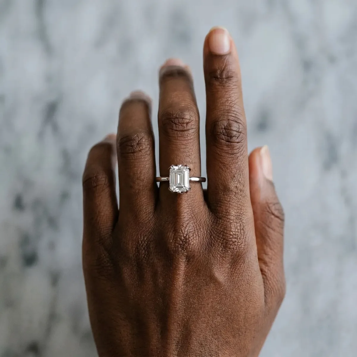 Emerald Cut Diamond Solitaire Ring with Flower Prong Setting and Classic Band Silver