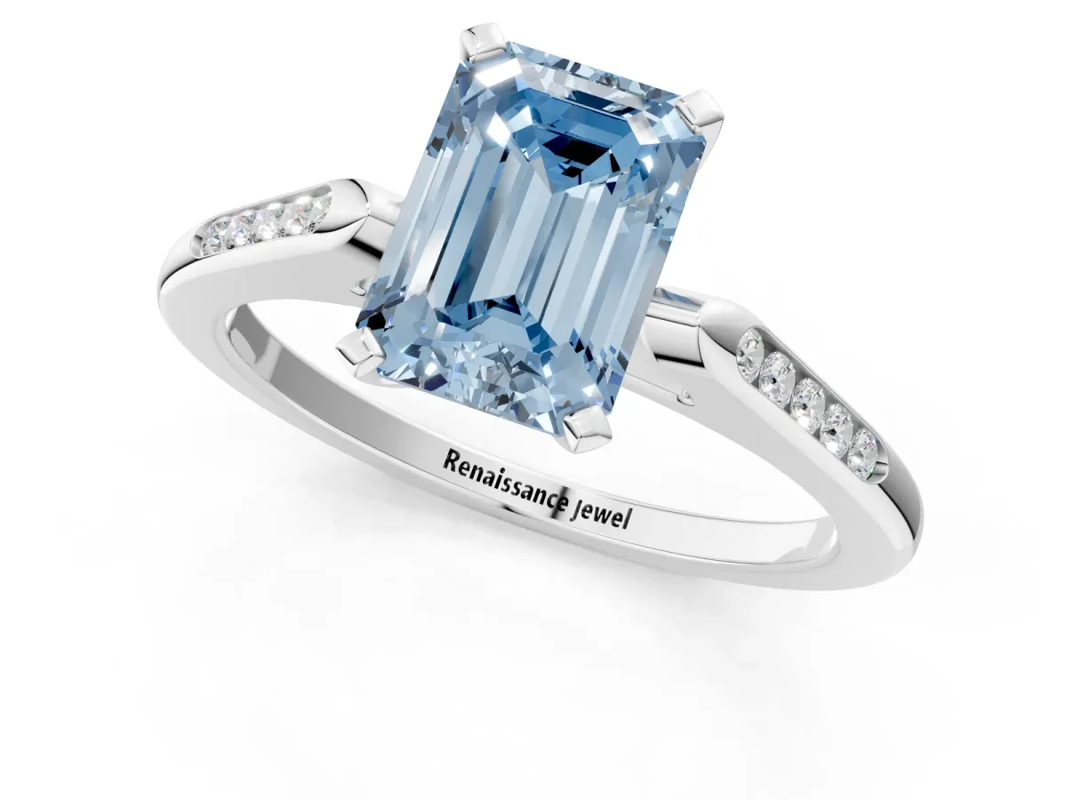Fancy Blue Emerald Cut Diamond Solitaire Ring with Channel Set Round Band and Prong Setting Silver
