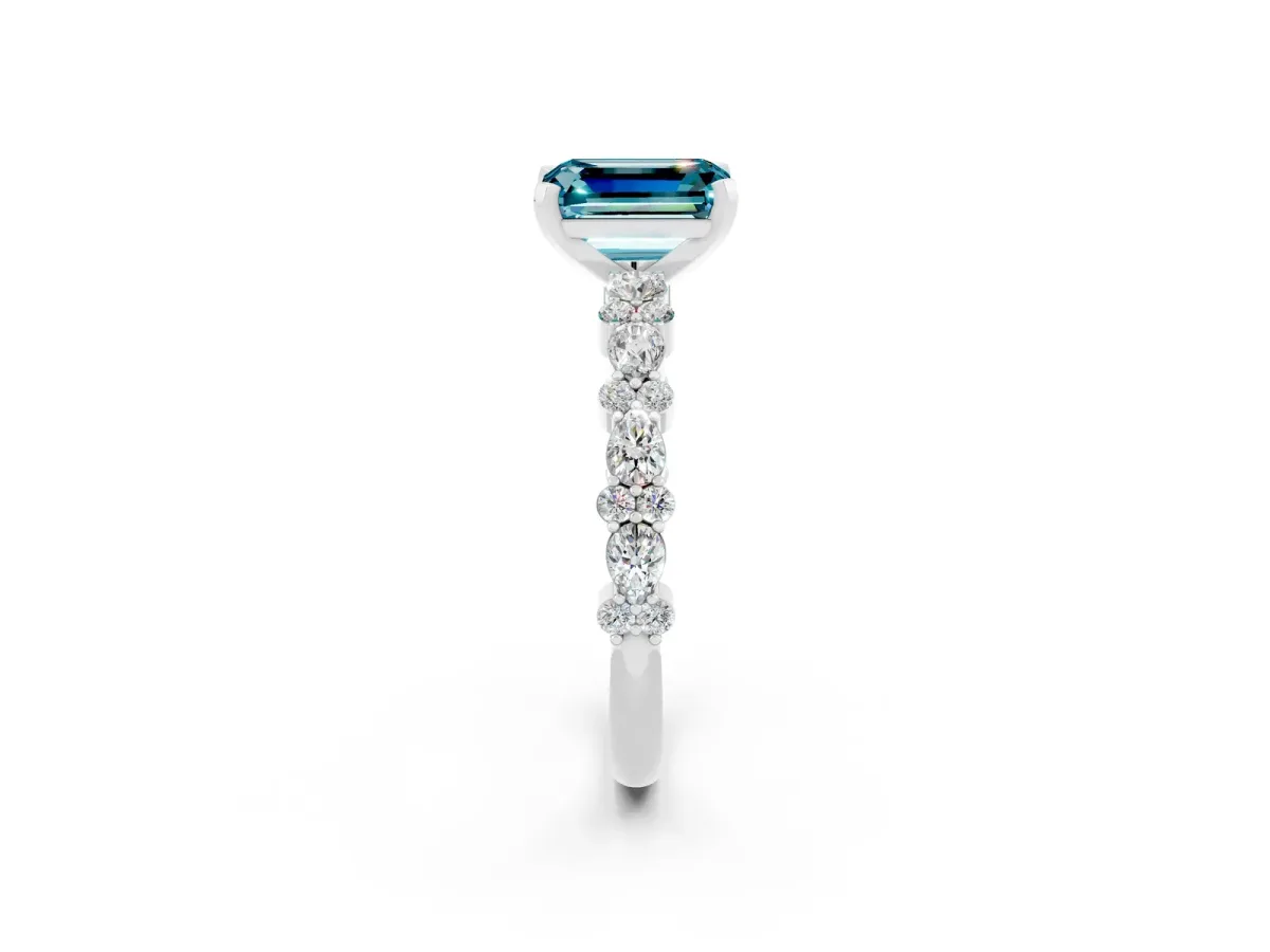 Emerald Cut Blue Topaz Side Stone Solitaire Ring with Round and Four-Prong Setting White gold