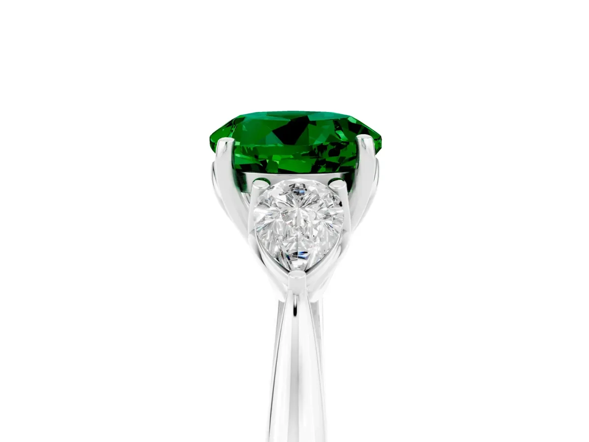 Three-Stone Round Cut Emerald Ring with Pear Side Stones in Four-Prong Setting Platinum