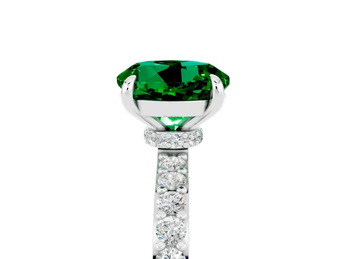 Round Cut Emerald Solitaire Engagement Ring with Pavé Band and Four-Prong Setting Silver