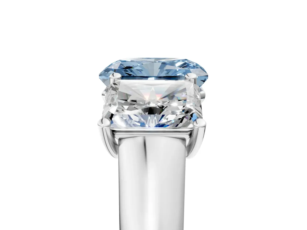 Fancy Blue Radiant Cut Three-Stone Diamond Ring with Prong Setting on a Classic Band Platinum