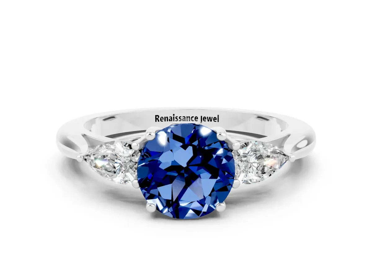Three-Stone Round Cut Blue Sapphire Ring with Pear Side Stones in Four-Prong Setting Platinum
