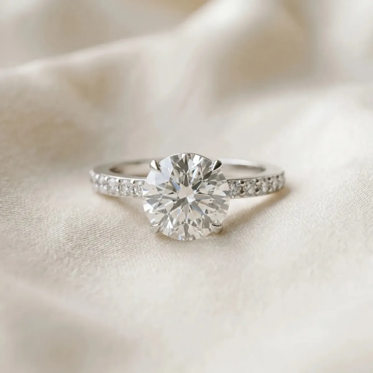 Round Cut Diamond Solitaire Engagement Ring with Pavé Band and Four-Prong Setting Silver