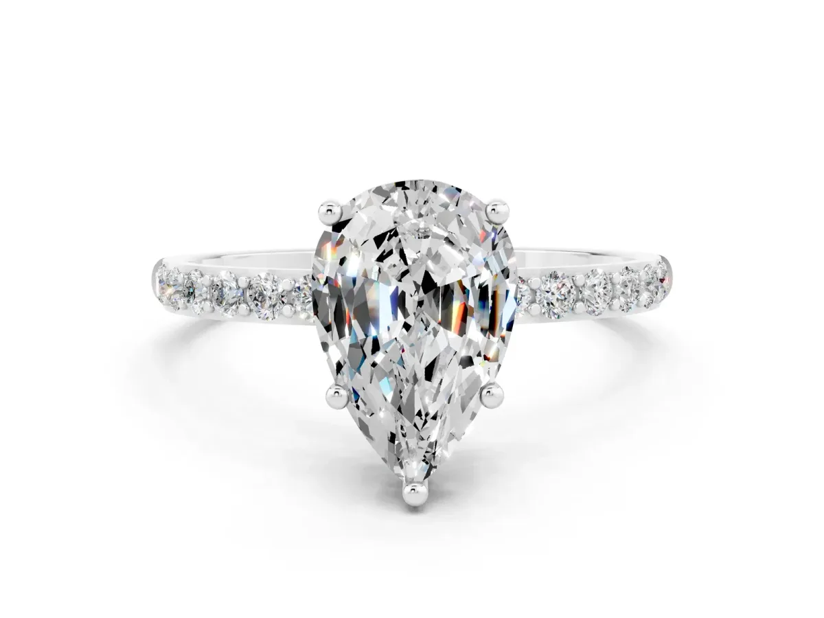 Pear Cut Moissanite Solitaire Ring with Round Pavé Band and Prong Setting Silver