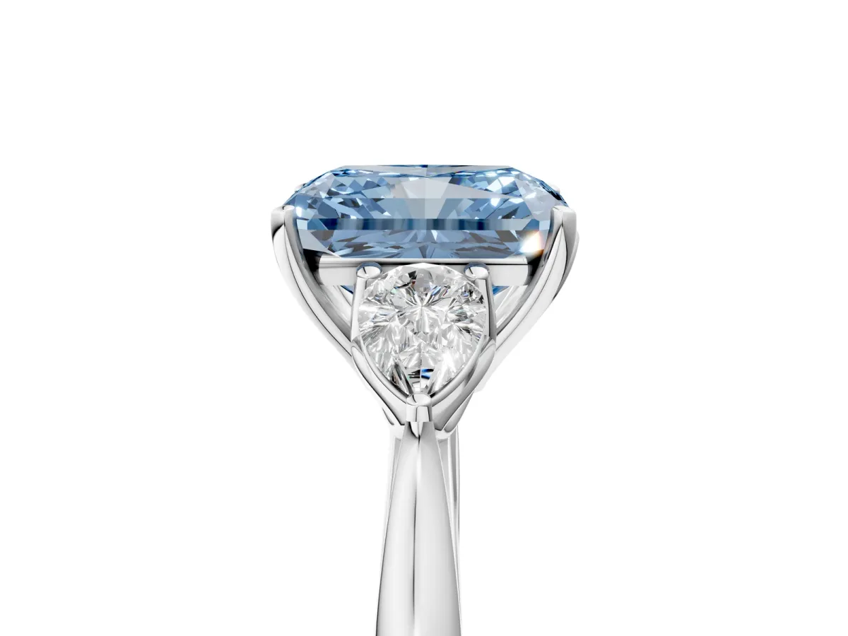 Fancy Blue Three-Stone Radiant Cut Diamond Ring with Pear Side Stones in Four-Prong Setting Platinum