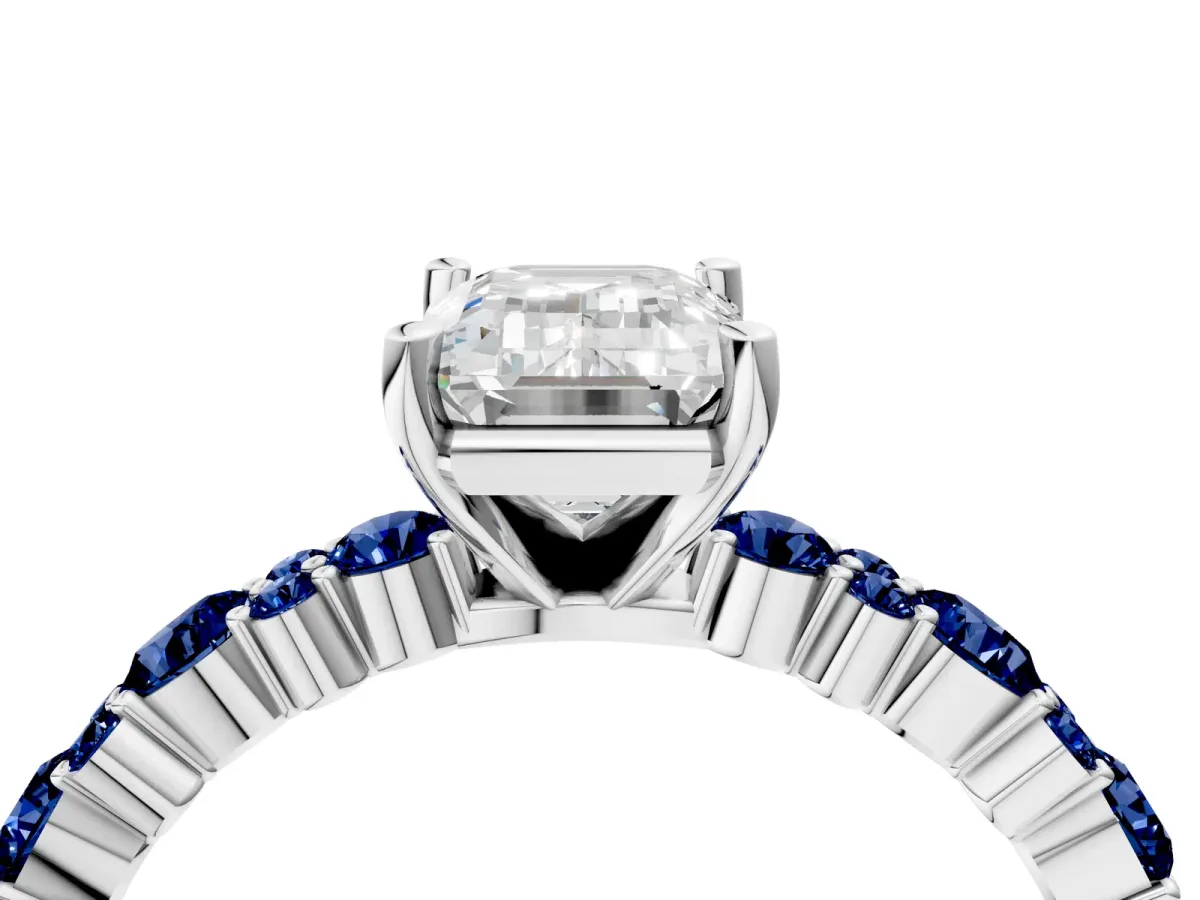 Emerald Cut Diamond Side Stone Solitaire Ring with Round Blue Sapphire and Four-Prong Setting Platinum