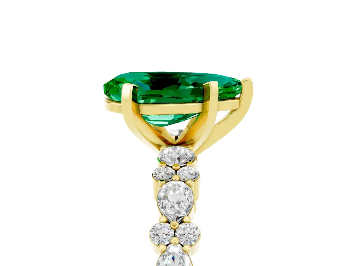 Pear Cut Emerald Side Stone Solitaire Ring with Round and Four-Prong Setting Yellow gold