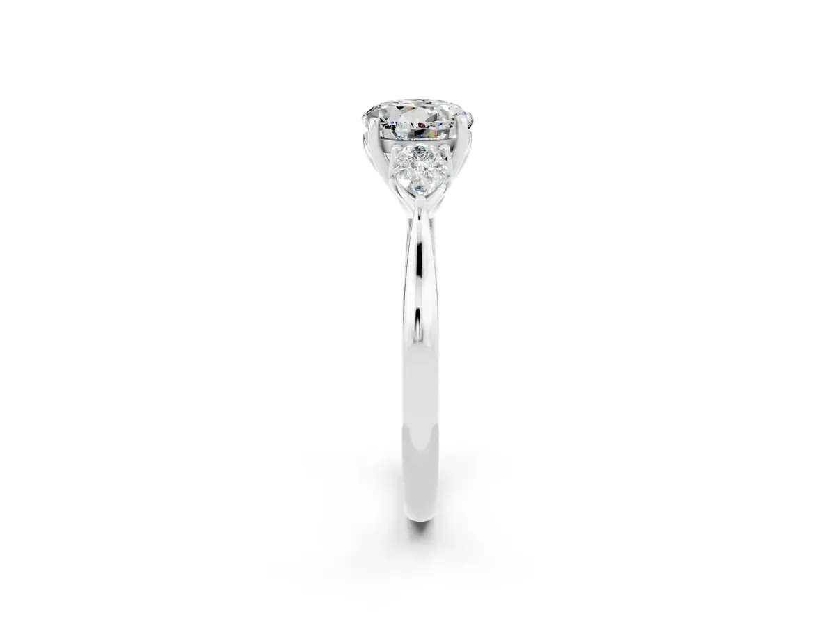 Three-Stone Round Cut Moissanite Ring with Pear Side Stones in Four-Prong Setting Platinum