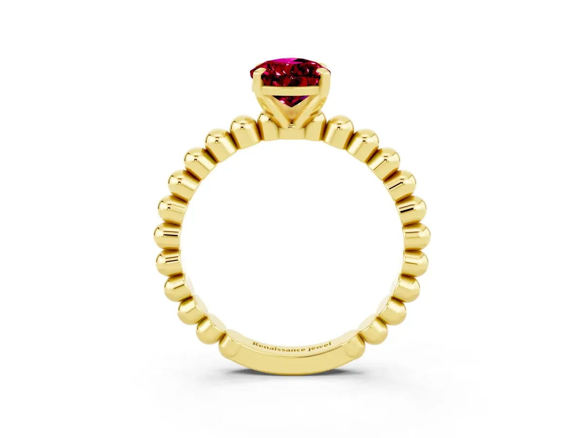 Pear Cut Garnet Solitaire Ring with Beaded Band and Prong Setting Yellow gold