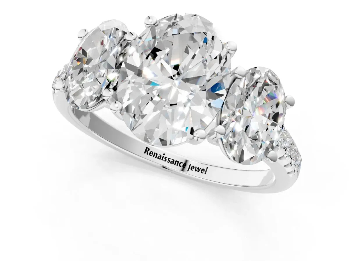 Three-Stone Oval Cut Diamond Ring with Round Pavé Band and Prong Setting Platinum