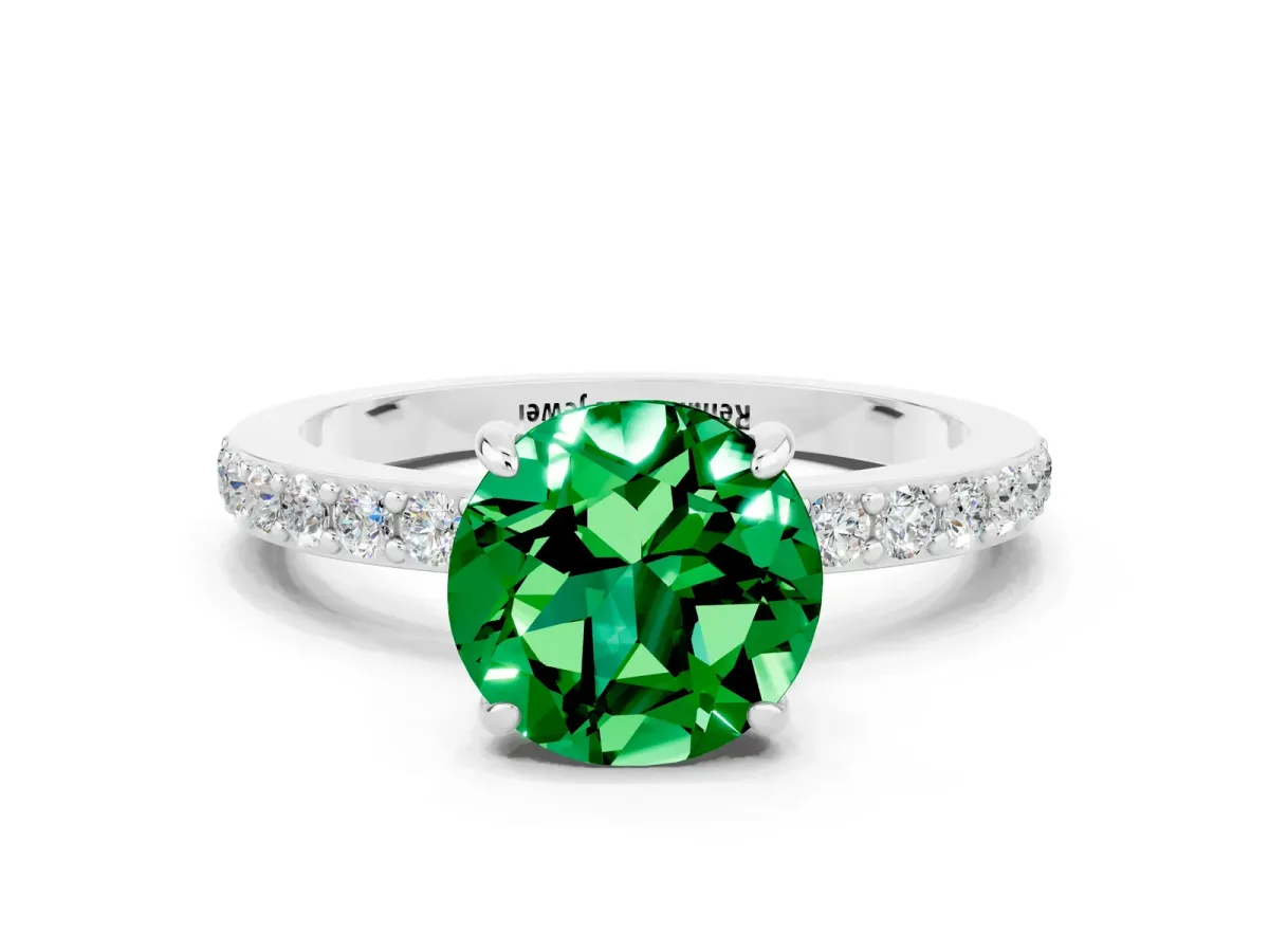 Round Cut Emerald Solitaire Engagement Ring with Pavé Band and Four-Prong Setting Silver