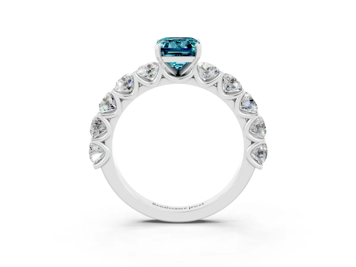 Emerald Cut Blue Topaz Prong Setting with Side Stones on a Pave Band Silver