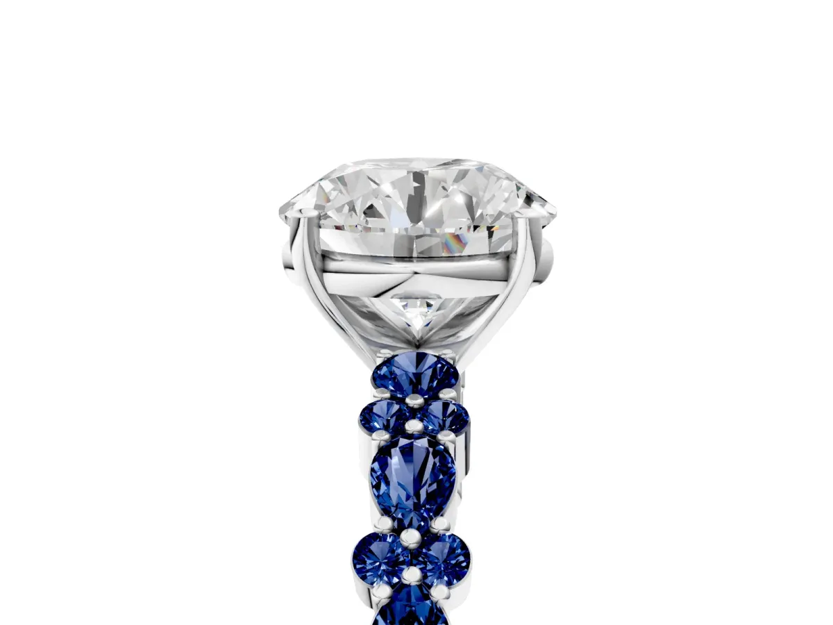 Round Cut Diamond Side Stone Solitaire Ring with Round Blue Sapphire and Four-Prong Setting Platinum