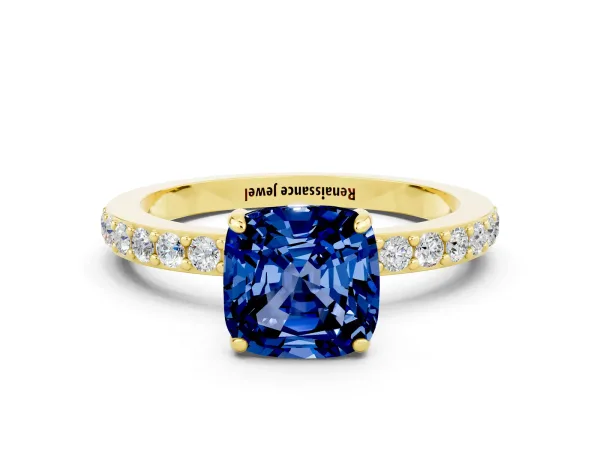 Cushion Cut Blue Sapphire Solitaire Engagement Ring with Pavé Band and Four-Prong Setting Yellow gold