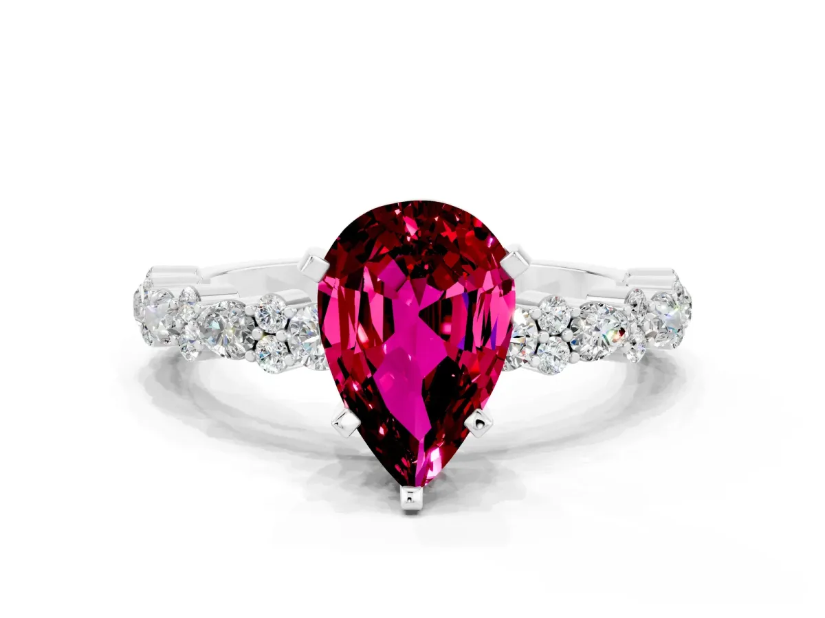 Pear Cut Garnet Side Stone Solitaire Ring with Round and Four-Prong Setting Silver
