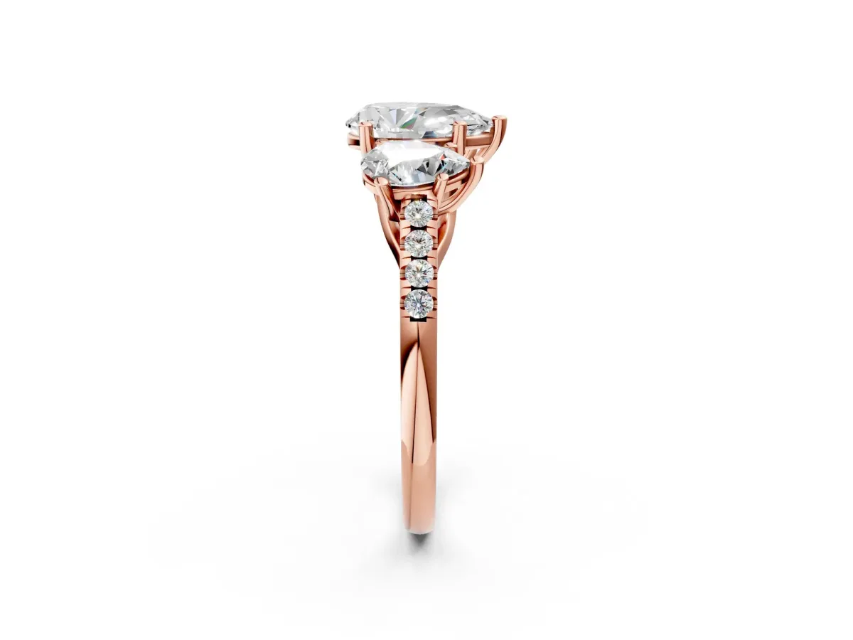 Three-Stone Pear Cut Diamond Ring with Round Pavé Band and Prong Setting Rose gold