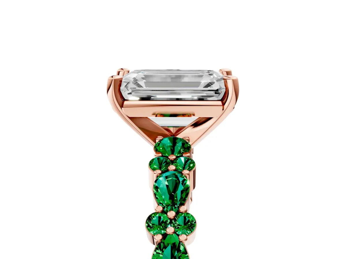 Emerald Cut Diamond Side Stone Solitaire Ring with Round Emerald and Four-Prong Setting Rose gold