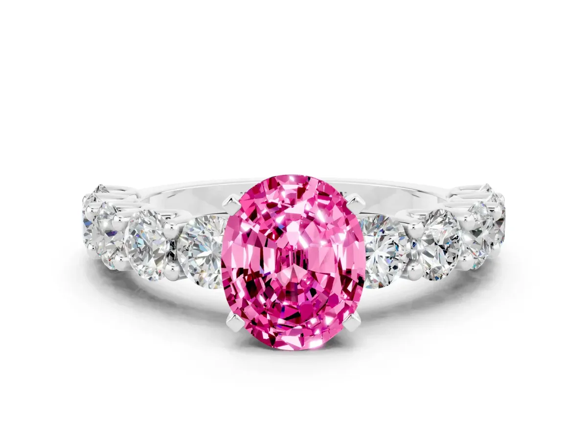 Oval Cut Pink Sapphire Prong Setting with Side Stones on a Pave Band Silver