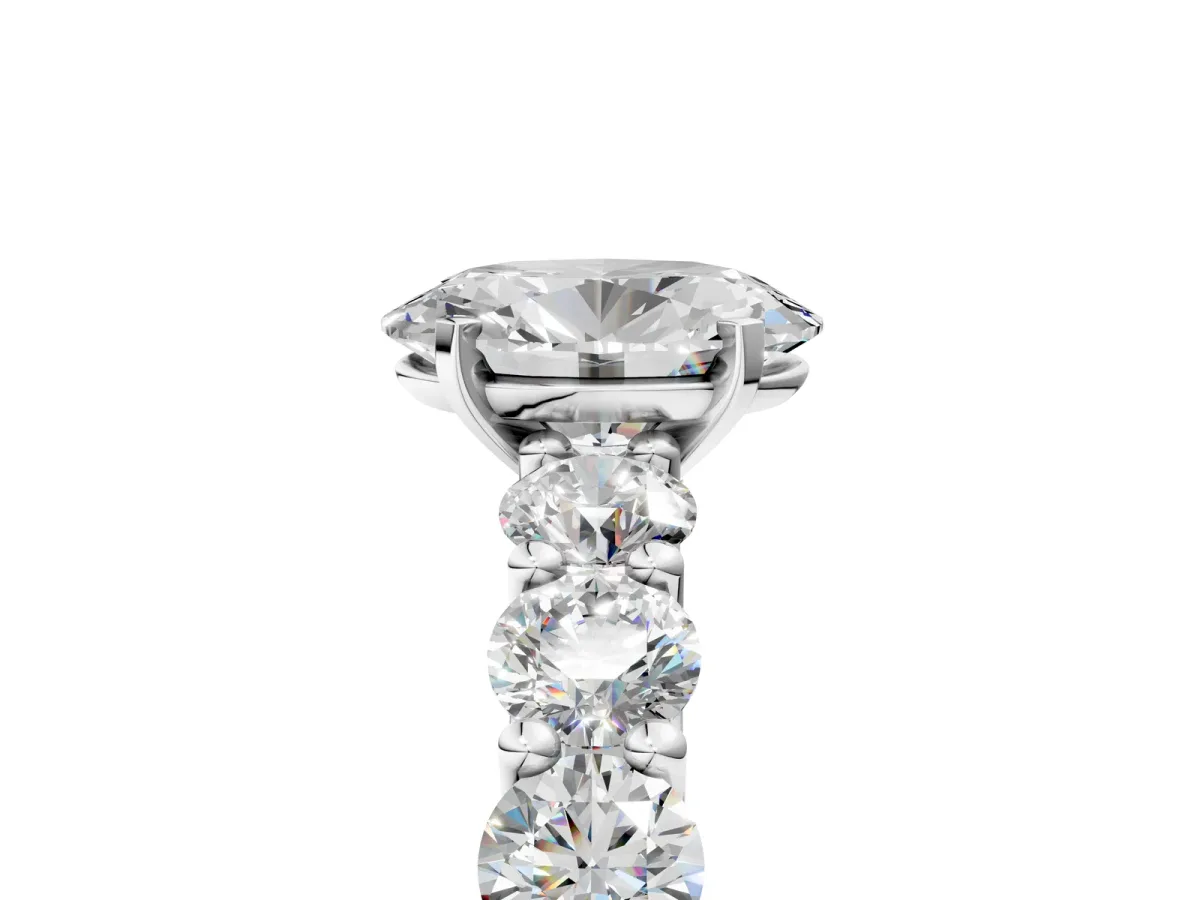Oval Cut Diamond Prong Setting with Side Stones on a Pave Band Platinum