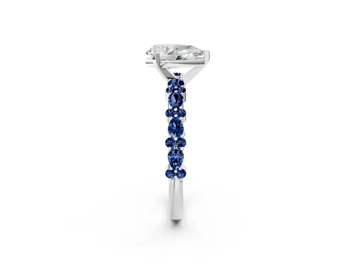 Pear Cut Diamond Side Stone Solitaire Ring with Round Blue Sapphire and Four-Prong Setting Silver