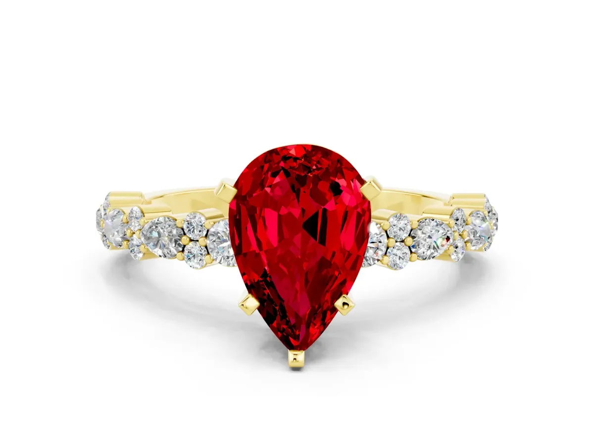 Pear Cut Ruby Side Stone Solitaire Ring with Round and Four-Prong Setting Yellow gold