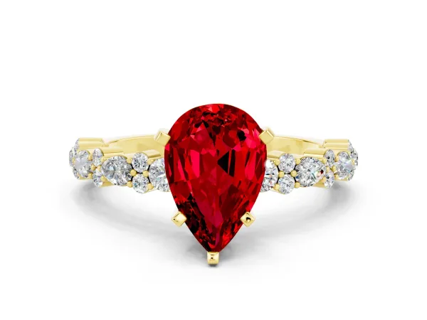 Pear Cut Ruby Side Stone Solitaire Ring with Round and Four-Prong Setting Yellow gold