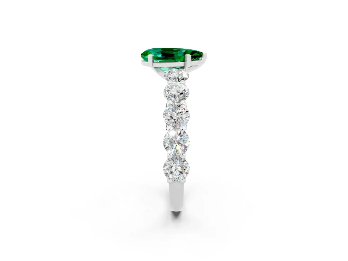 Pear Cut Emerald Prong Setting with Side Stones on a Pave Band Silver