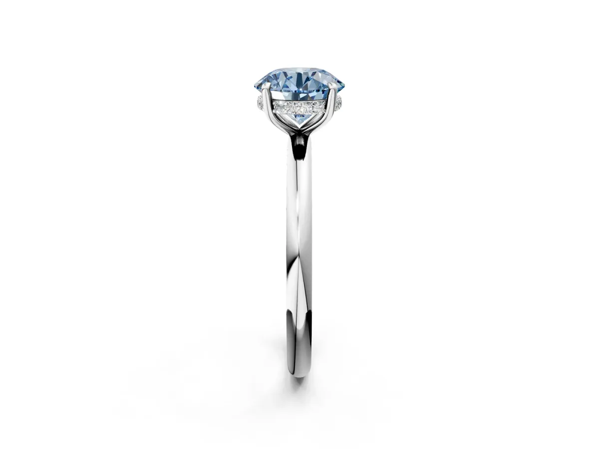 Fancy Blue Round Cut Diamond Solitaire Ring with Thin Band and Four-Prong Setting Silver