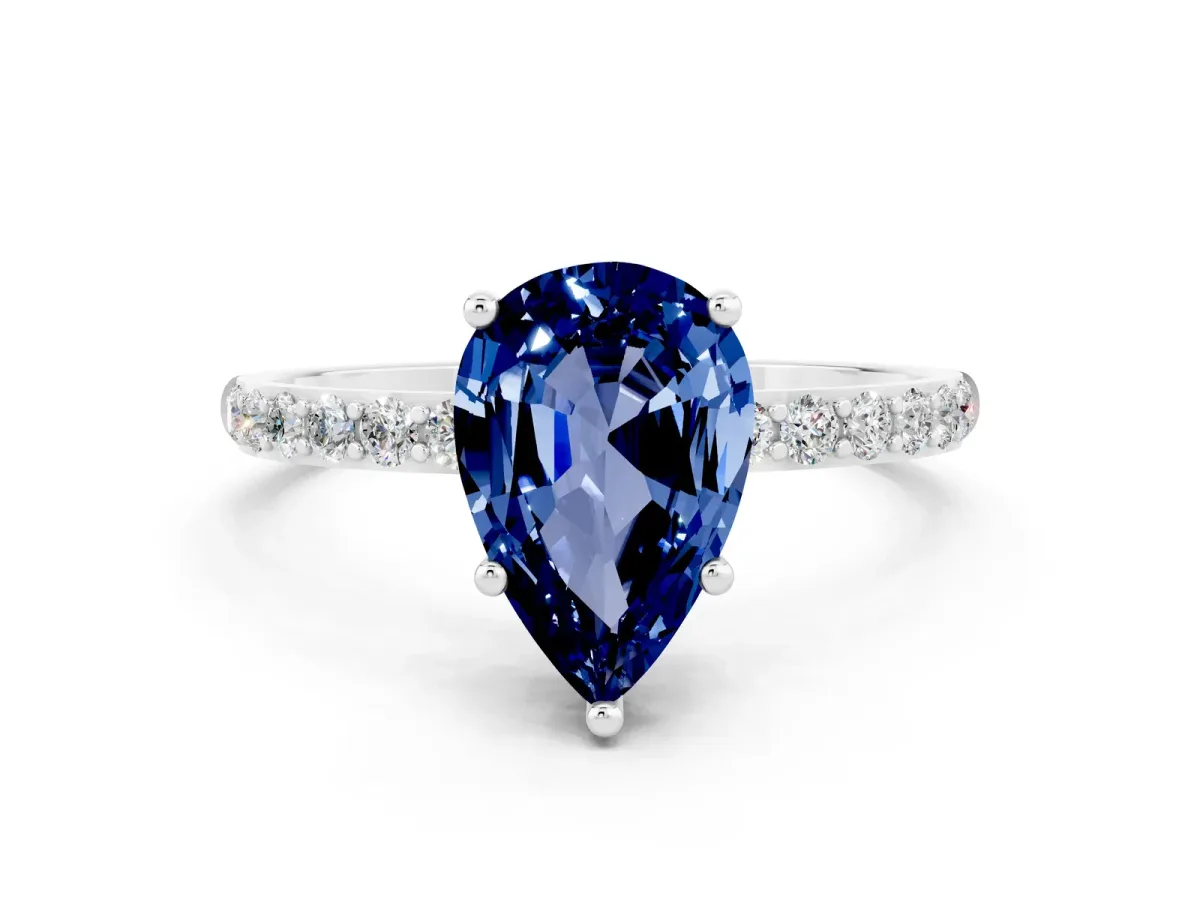 Pear Cut Blue Sapphire Solitaire Ring with Round Pavé Band and Prong Setting Silver