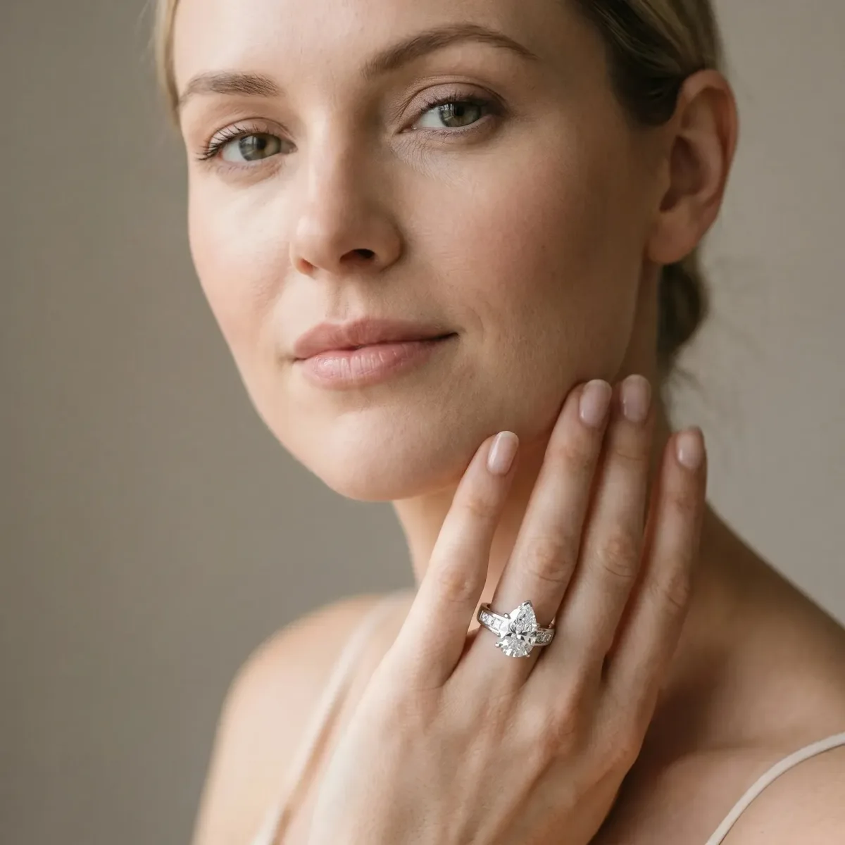 Pear Cut Cut Channel Set Solitaire Ring with Four-Prong Setting Platinum
