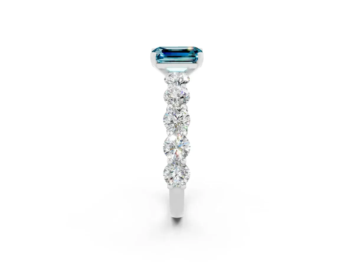 Emerald Cut Blue Topaz Prong Setting with Side Stones on a Pave Band Silver