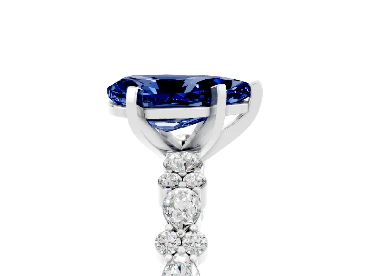 Pear Cut Blue Sapphire Side Stone Solitaire Ring with Round and Four-Prong Setting Silver