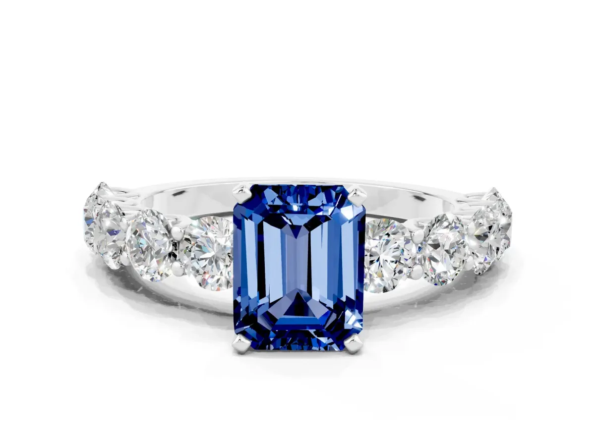 Emerald Cut Blue Sapphire Prong Setting with Side Stones on a Pave Band Silver