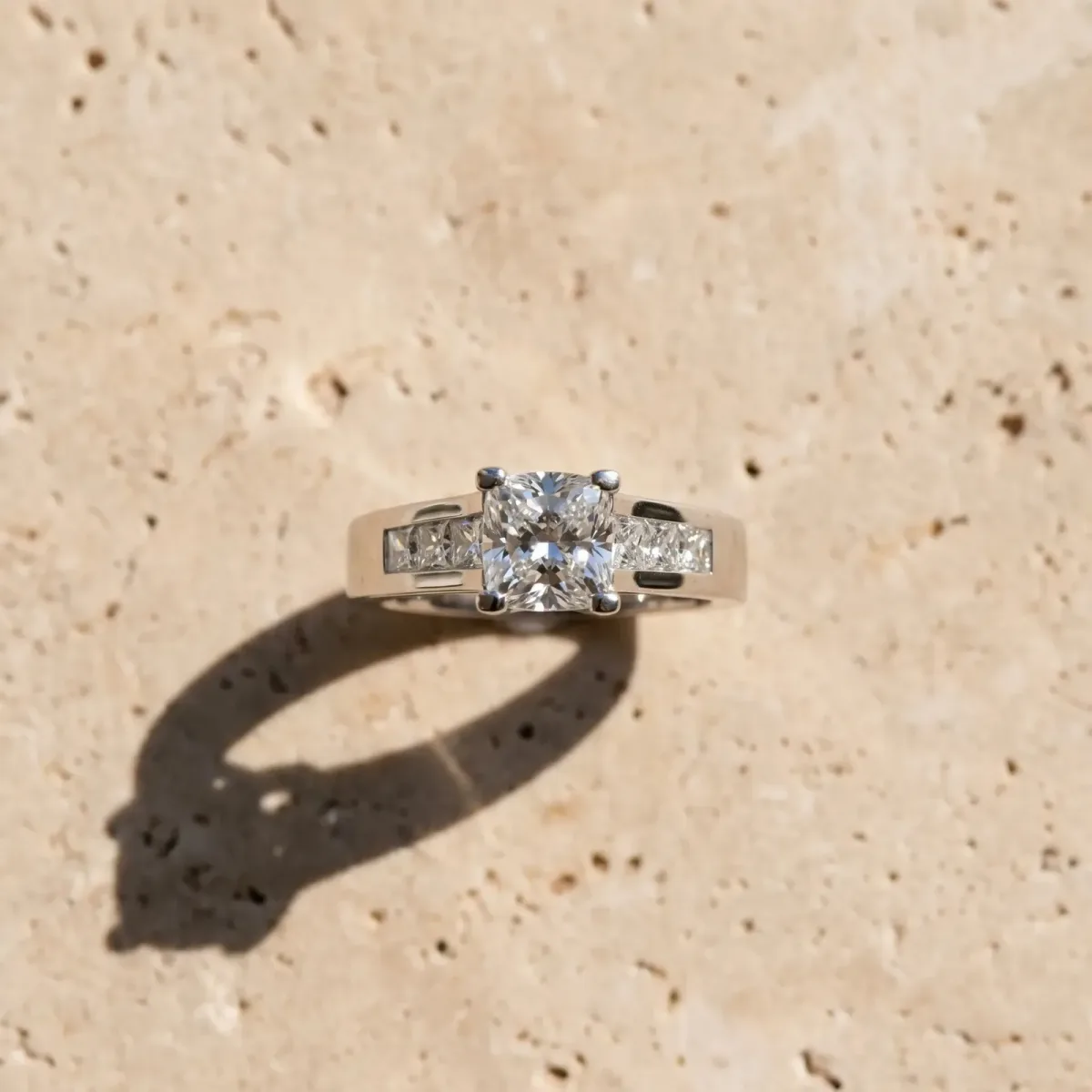 Cushion Cut Cut Channel Set Solitaire Ring with Four-Prong Setting Platinum