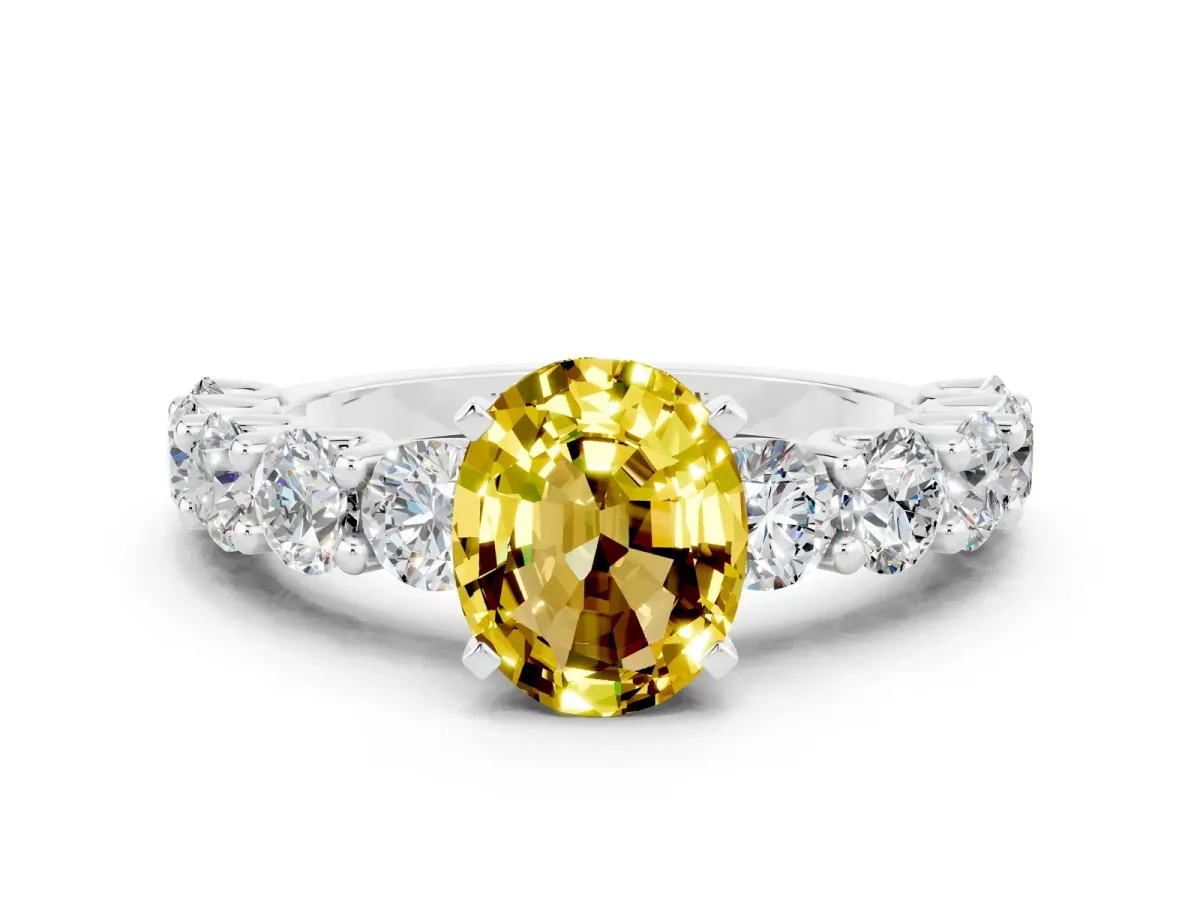 Oval Cut Yellow Sapphire Prong Setting with Side Stones on a Pave Band Silver